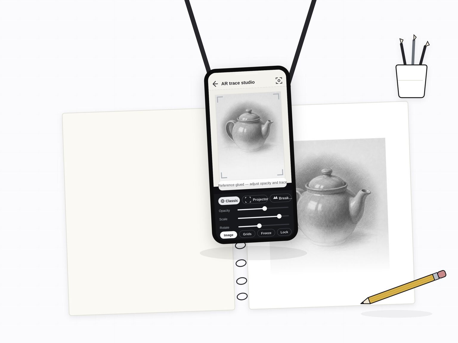 Illustration: a phone on a tripod arm held flat over a sketchbook, the AR trace studio showing a teapot reference over the page