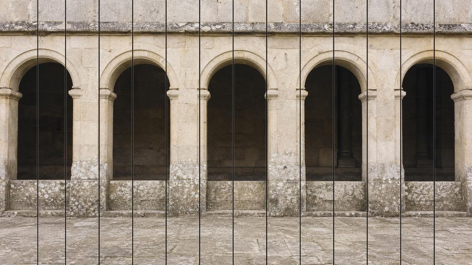 Column grid overlay on a stone cloister arcade of even bays separated by equal piers