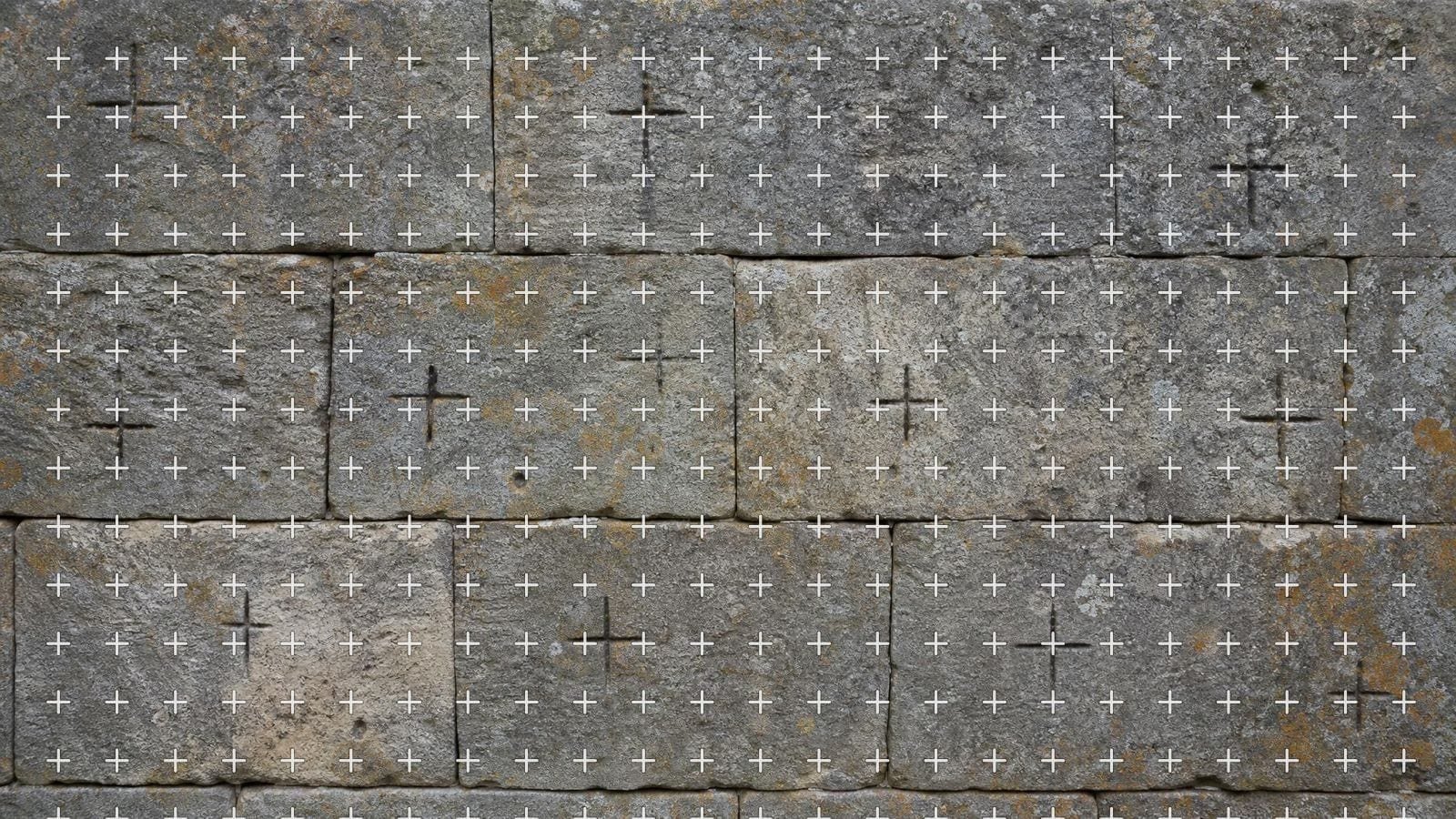 Crosshair grid overlay on an ashlar wall carrying small chiselled survey cross marks