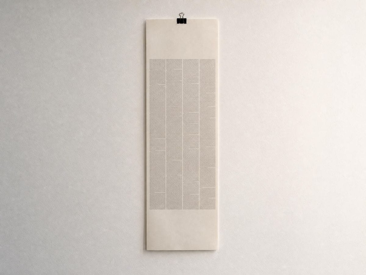 A long galley proof hanging from a clip, its type set in even unreadable columns