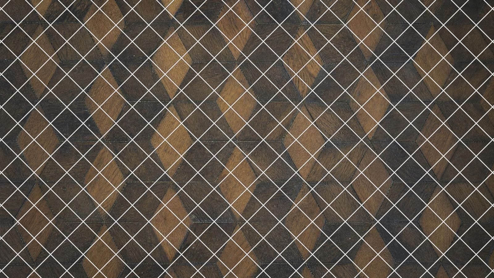 Diamond grid overlay on an oak parquet floor laid in a repeating lozenge pattern
