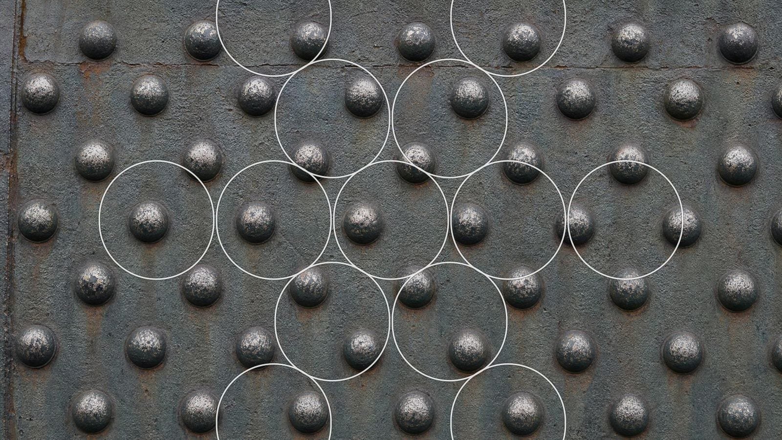 Fruit of Life overlay on riveted iron plate, rivet heads on a hexagonal lattice