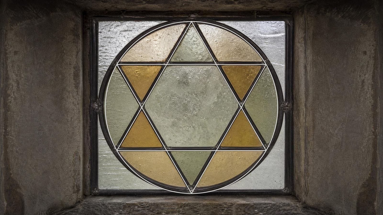 Hexagram overlay on a leaded glass panel of two interlocking equilateral triangles