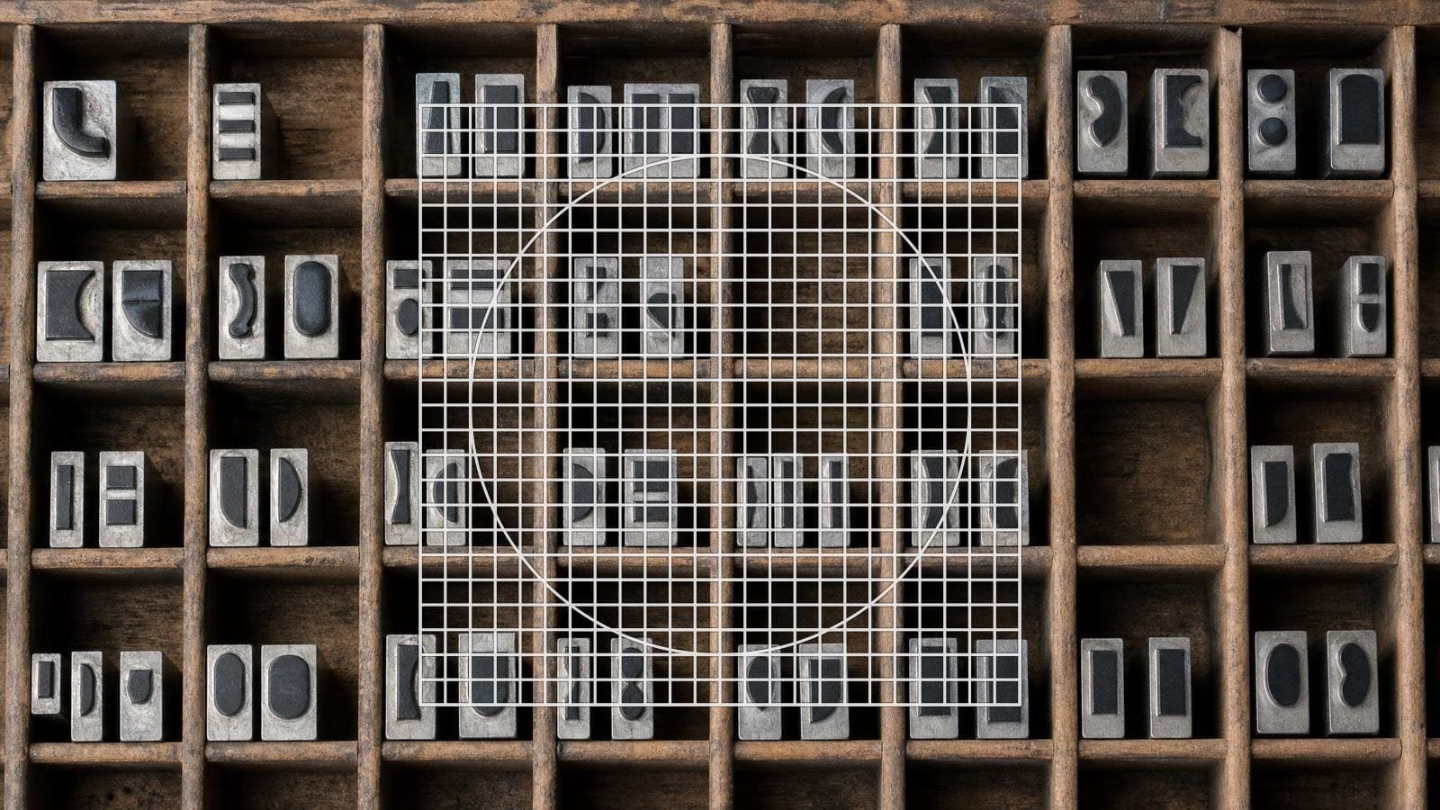 Icon grid overlay on metal type sorts standing in a case, each centred on its own body