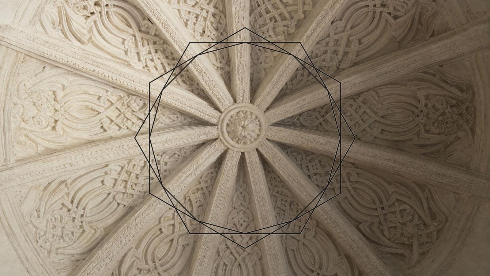 Islamic twelve-pointed star overlay on a carved plaster vault with twelve radial ribs