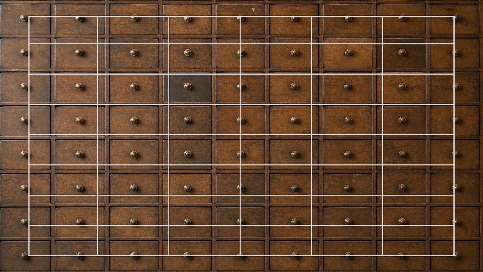 Modular grid overlay on a bank of apothecary drawers forming even columns and rows