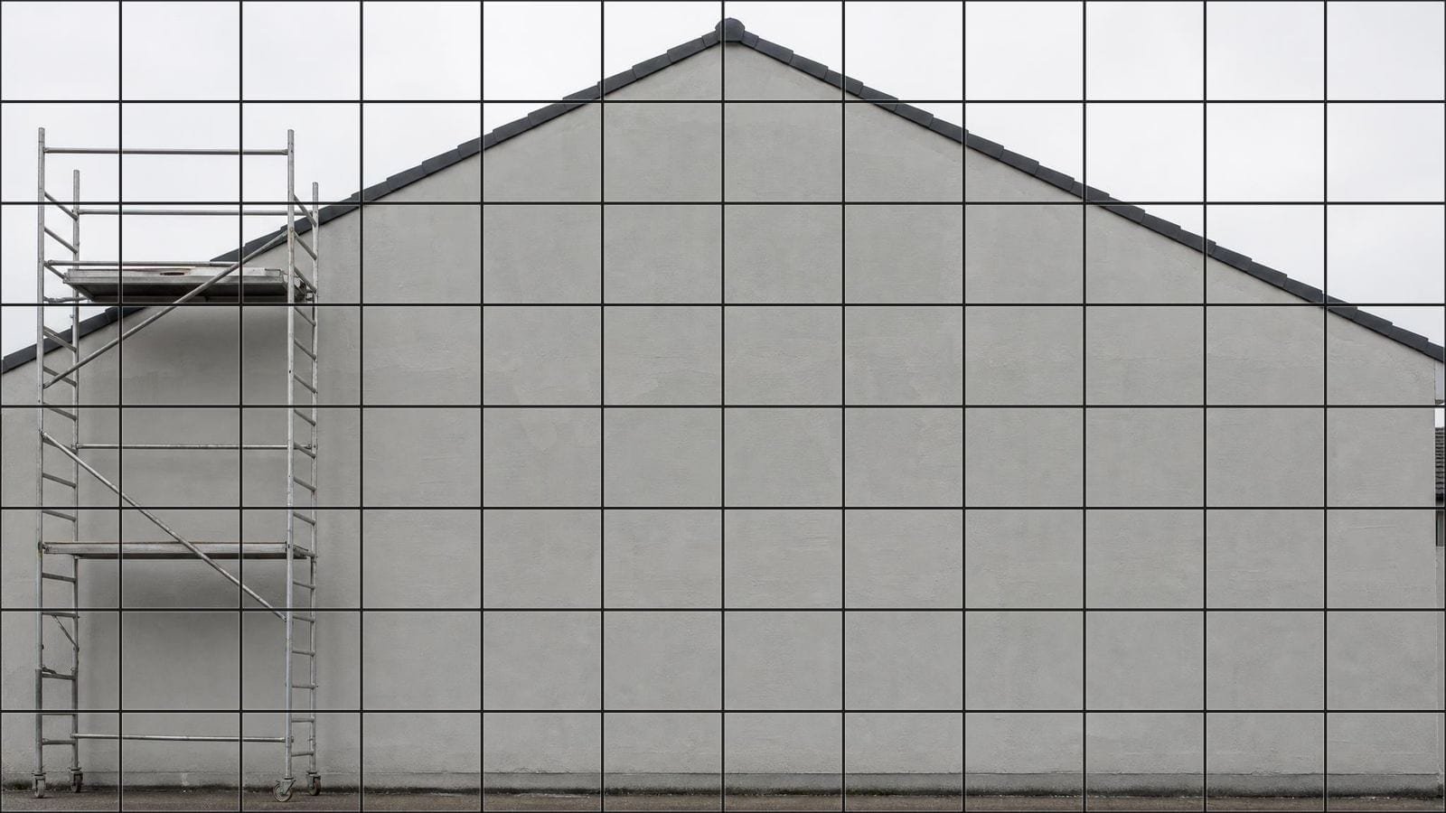Mural scaling grid overlay on a tall primed gable wall with a tower scaffold beside it