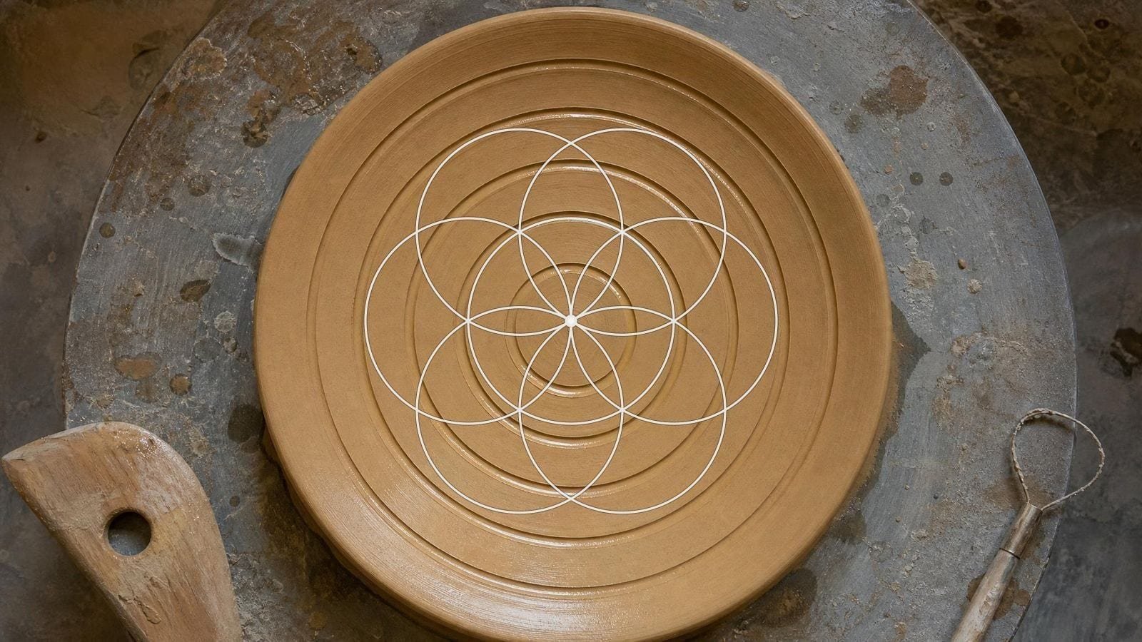 Seed of Life overlay on a thrown earthenware plate cut with six concentric rings