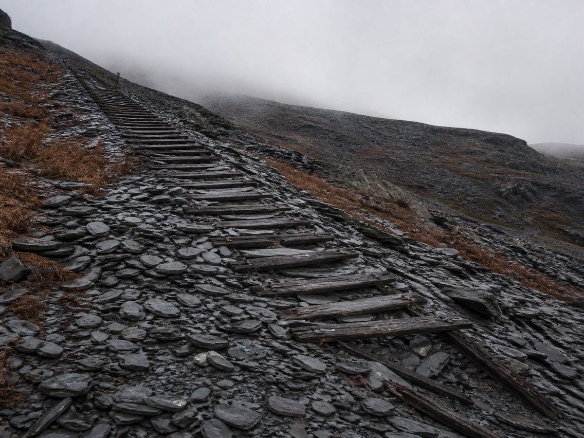 A ruined quarry incline running from upper left down to lower right across a slate hillside