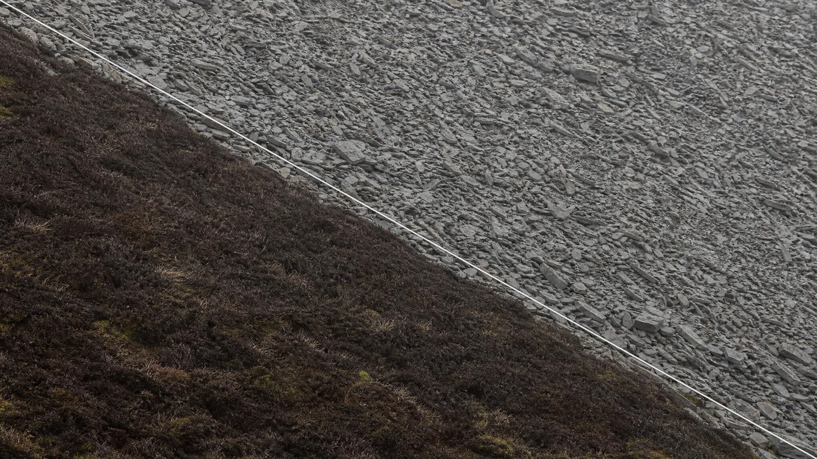 Sinister diagonal overlay on a scree slope falling from upper left to lower right