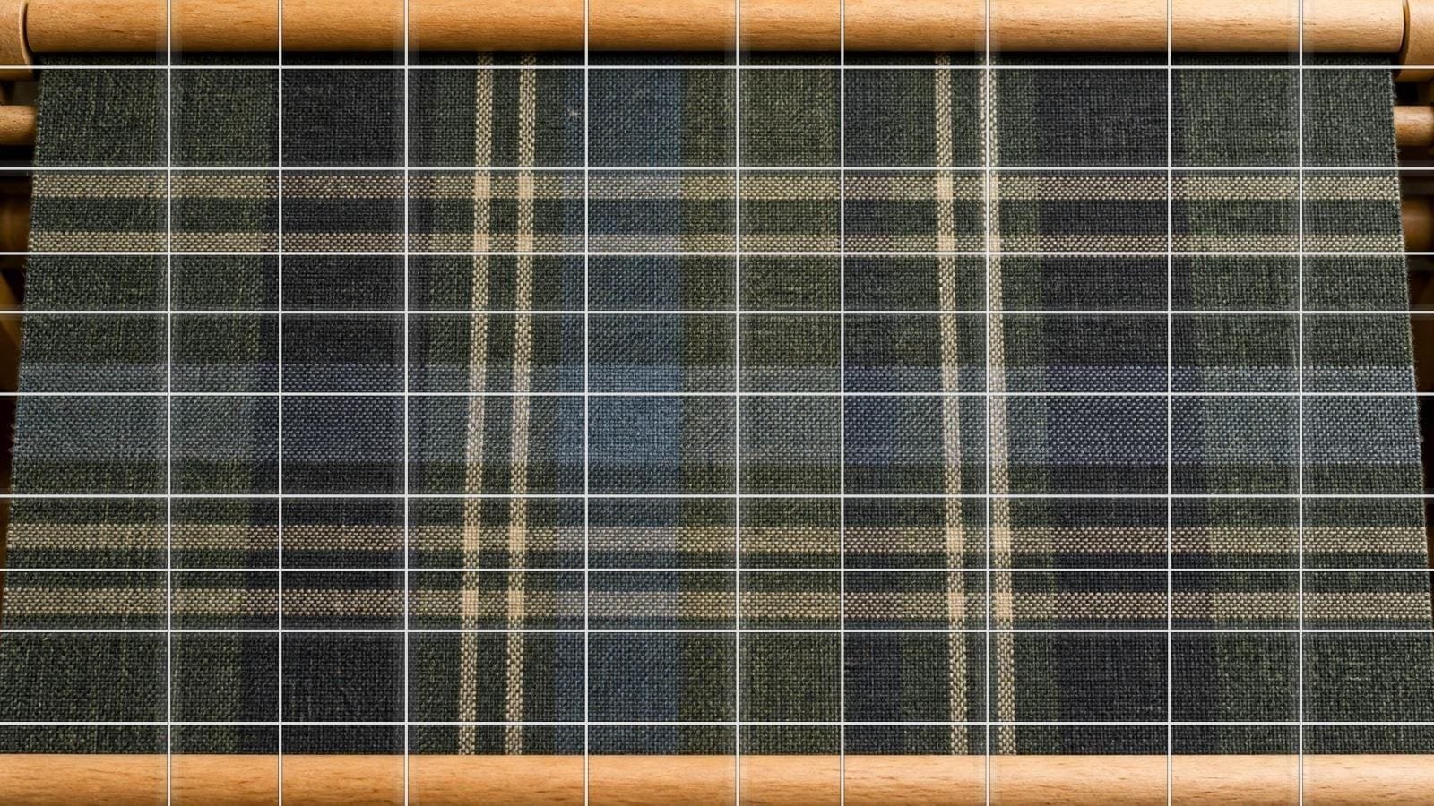 Tartan grid overlay on a woven wool sett, uneven bands crossing in both directions
