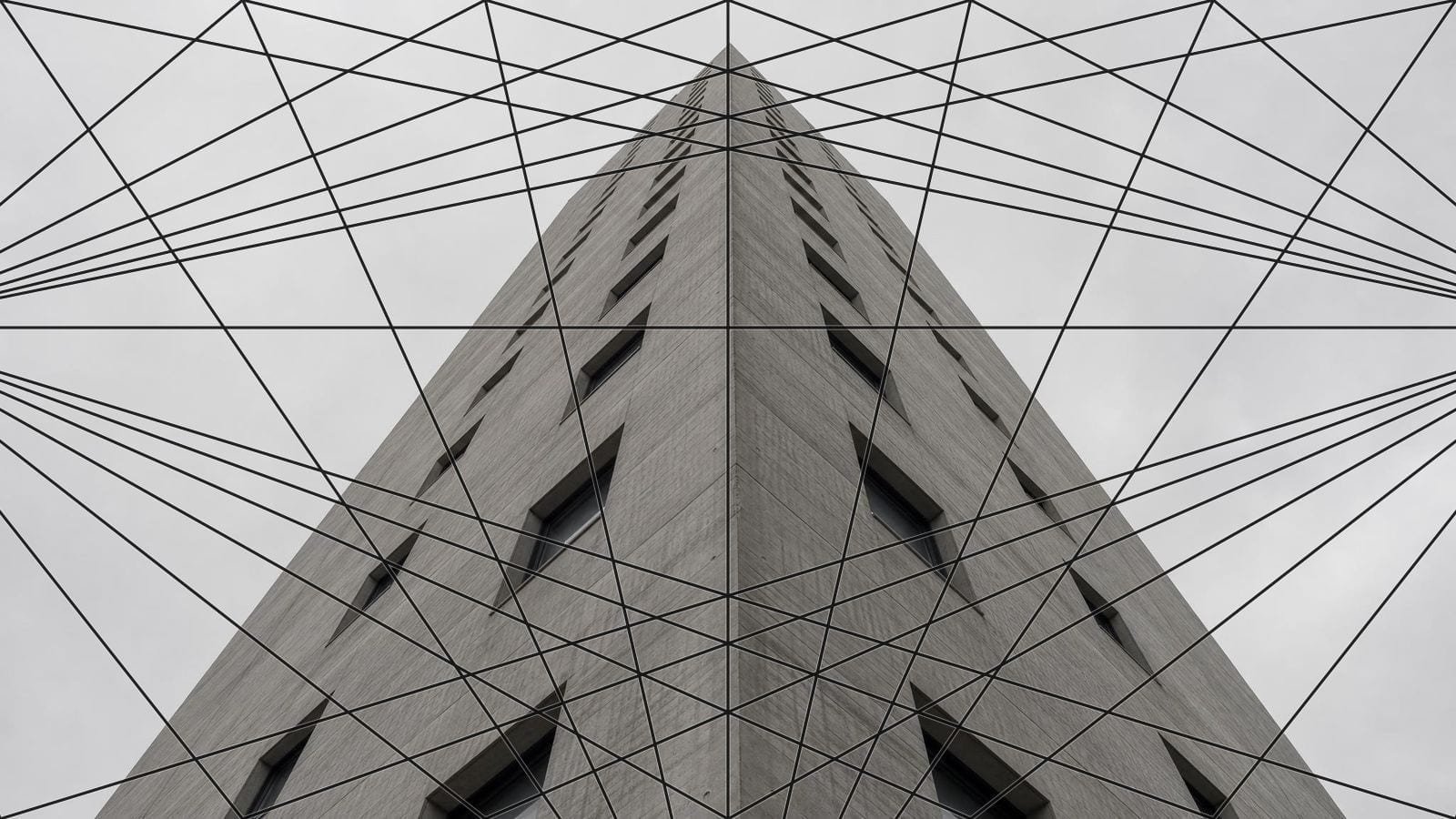 Three point perspective grid over a concrete tower with verticals converging above the frame