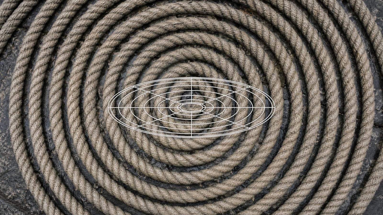 Torus field overlay on a heavy mooring rope coiled flat in rings around a centre