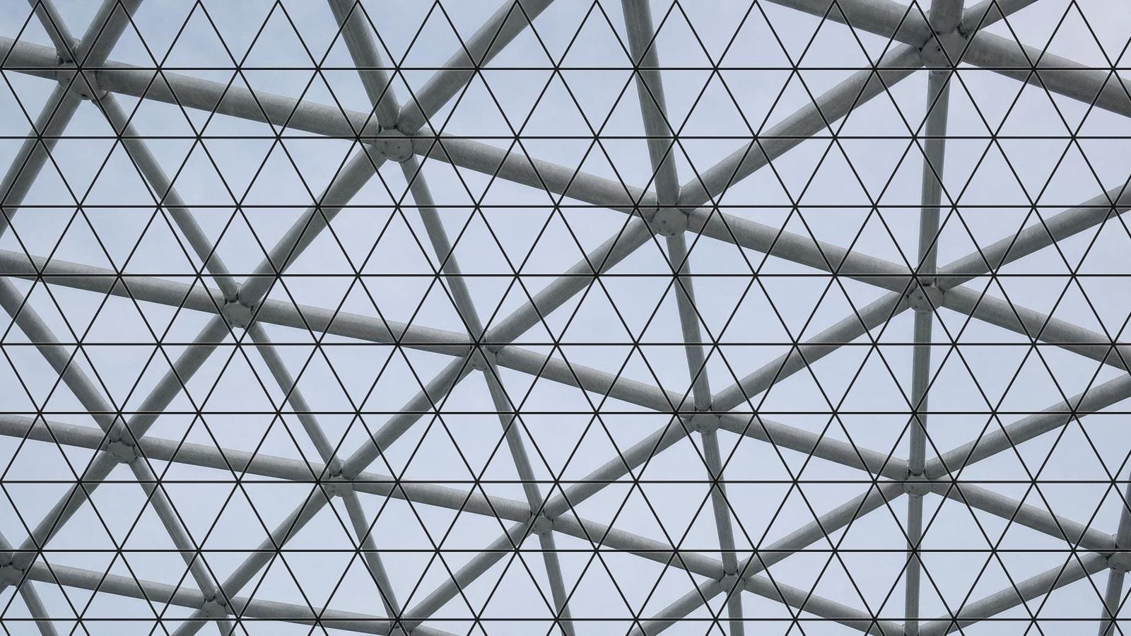 Triangular grid overlay on a steel space frame of equilateral triangles meeting at nodes
