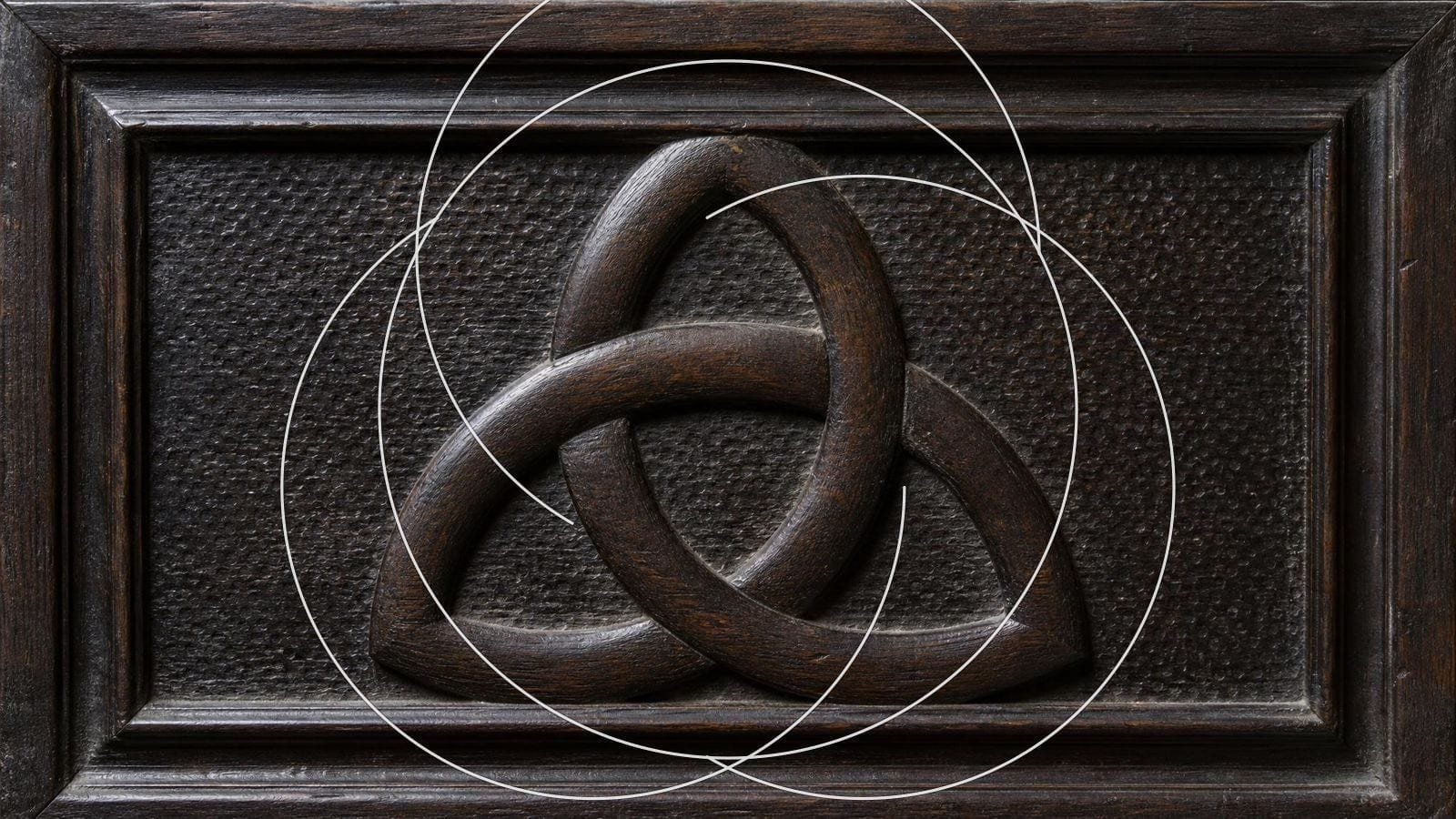 Triquetra overlay on a carved oak panel of three interlacing arcs of equal radius